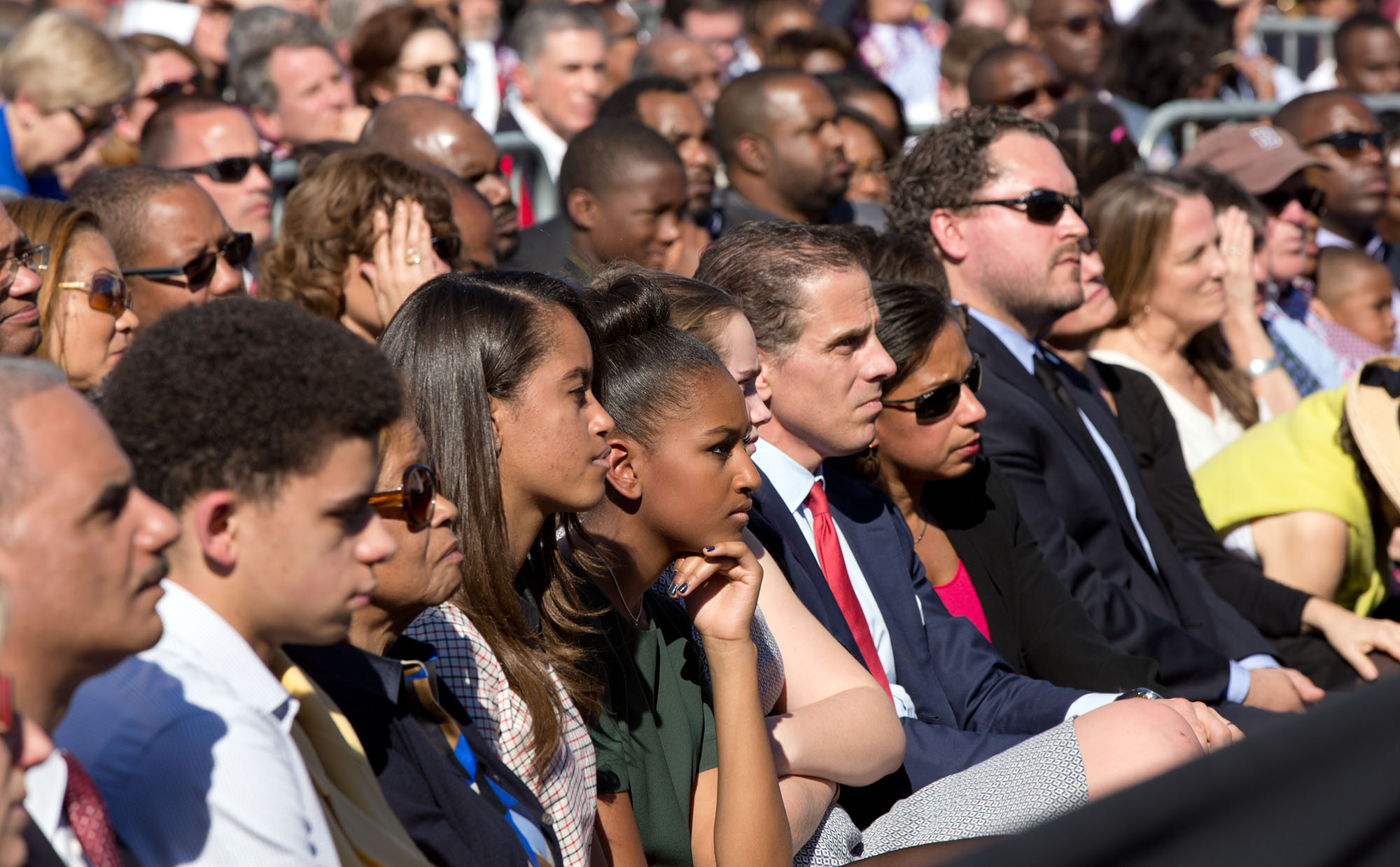 Malia and Sasha Obama and other family, friends, and White House staff listen to the President. Attorney General Eric Holder is at far left. (Official White House Photo by Pete Souza)
