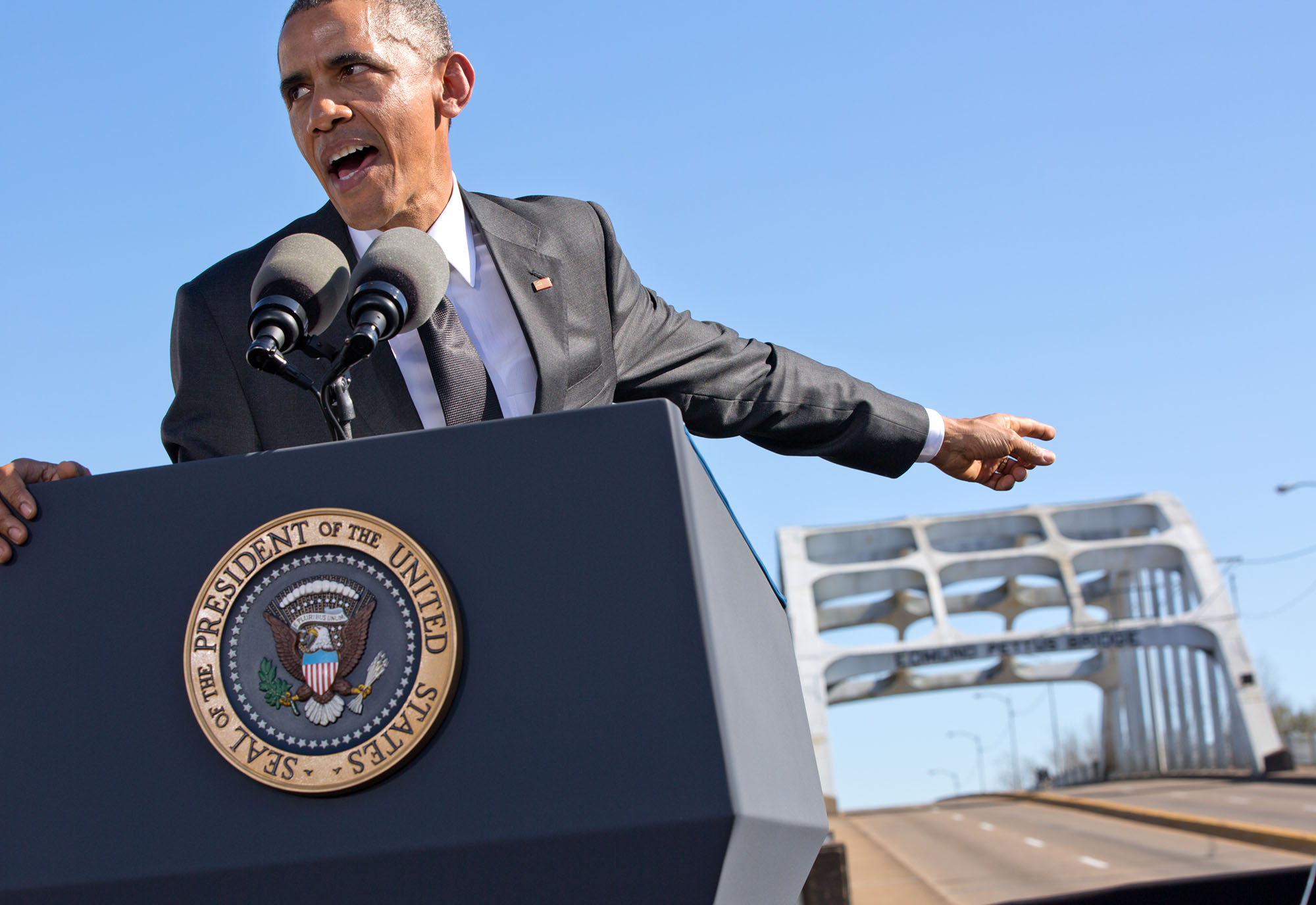 The President points towards the bridge during his speech. (Official White House Photo by Pete Souza)