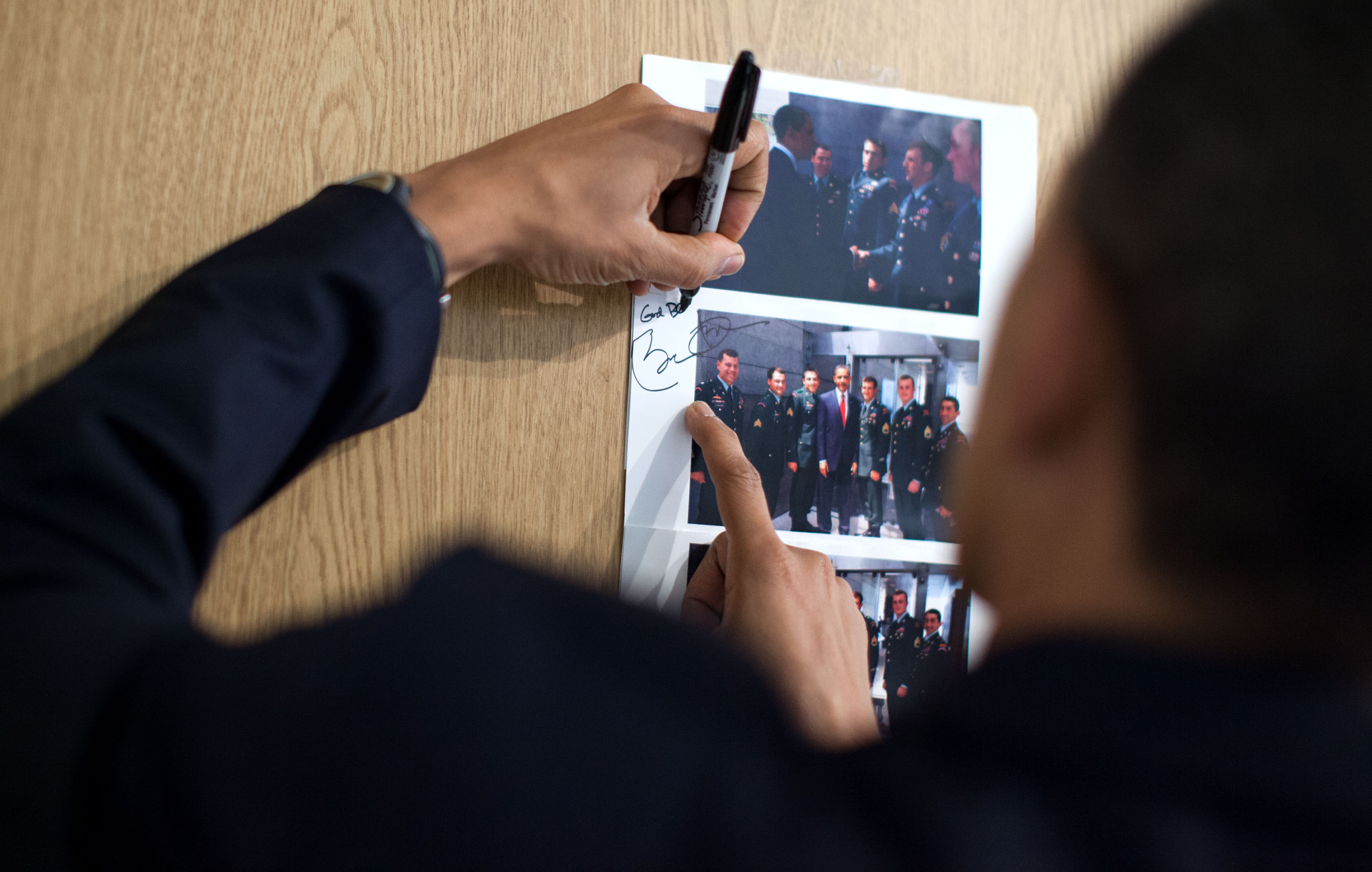 Feb. 28, 2010: The President signs a photo for Cory from their Normandy greeting. (Official White House Photo by Pete Souza)