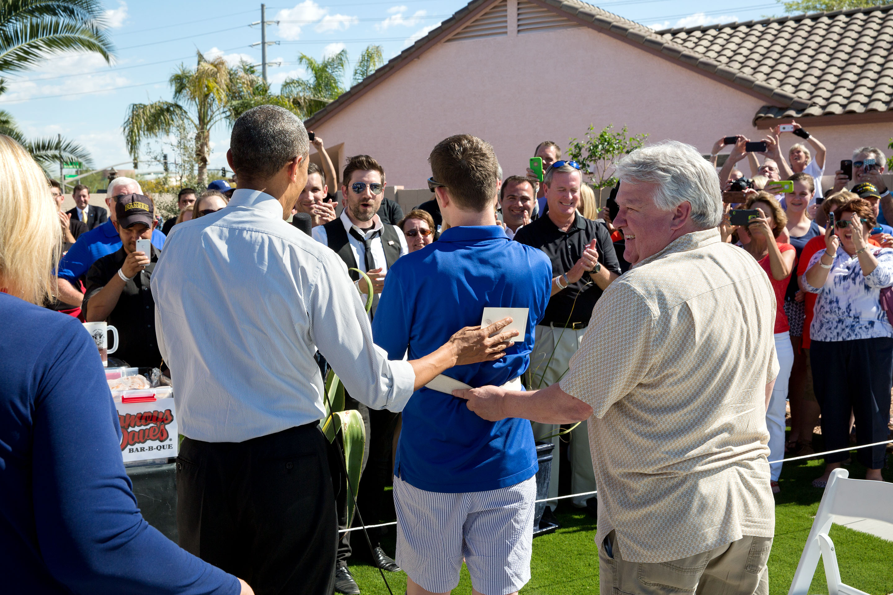 March 13, 2015: The President, Cory and his father Craig greet neighbors, volunteers and donors in the backyard of his home, which was purchased by the Army Ranger Lead the Way Fund and renovated with the help of Jared Allen's Homes for Wounded Warriors. (Official White House Photo by Pete Souza)