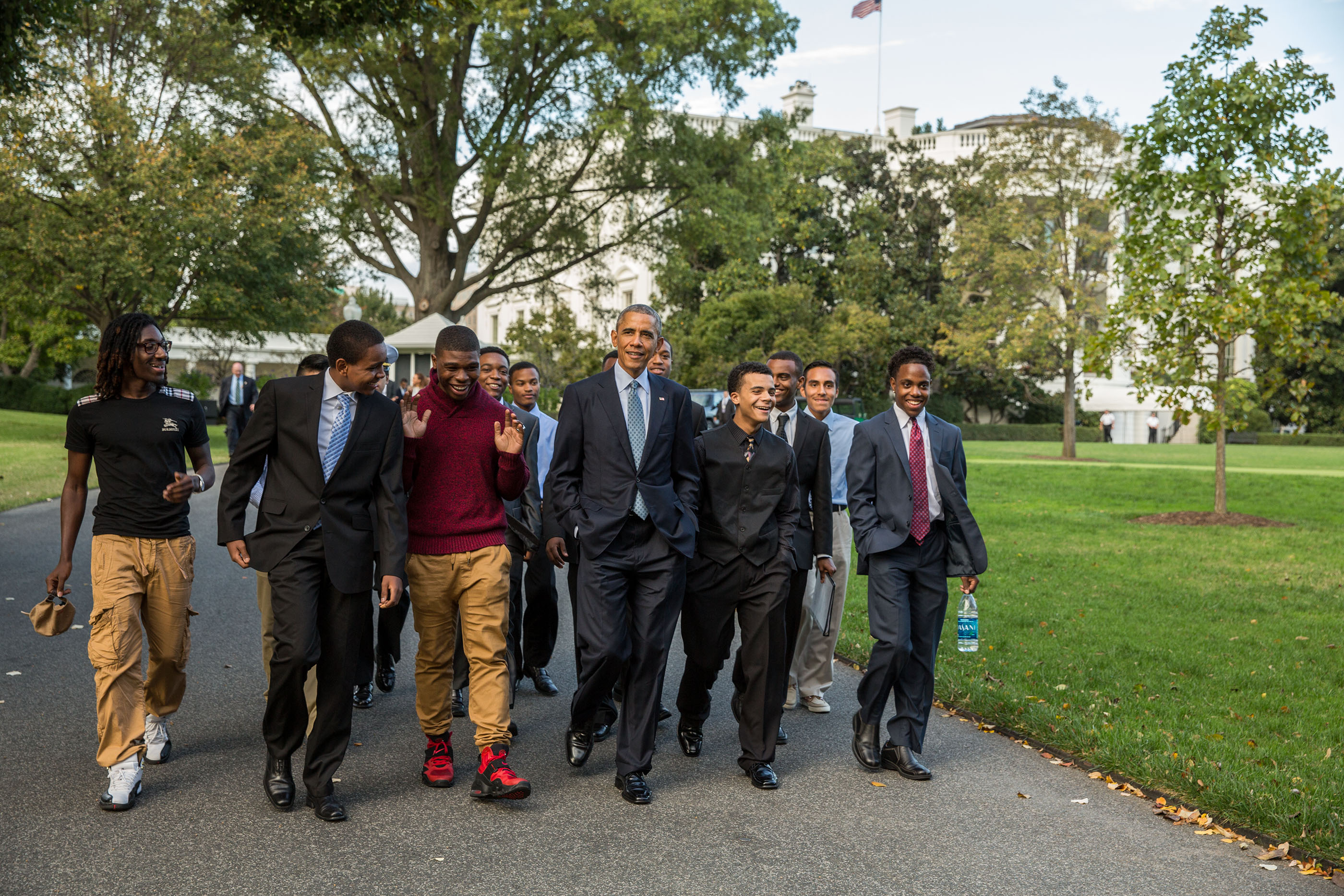 President Barack Obama walks with mentees on the South Lawn of the White House