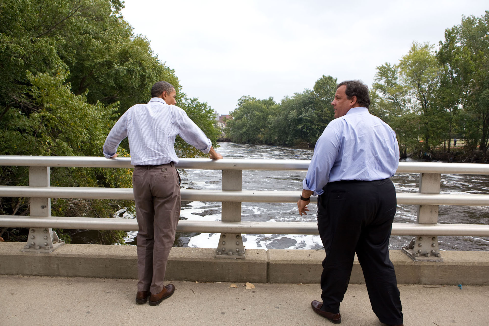 President Barack Obama and New Jersey Gov. Chris Christie look at the swollen Passaic River from the Main Street Bridge in Paterson