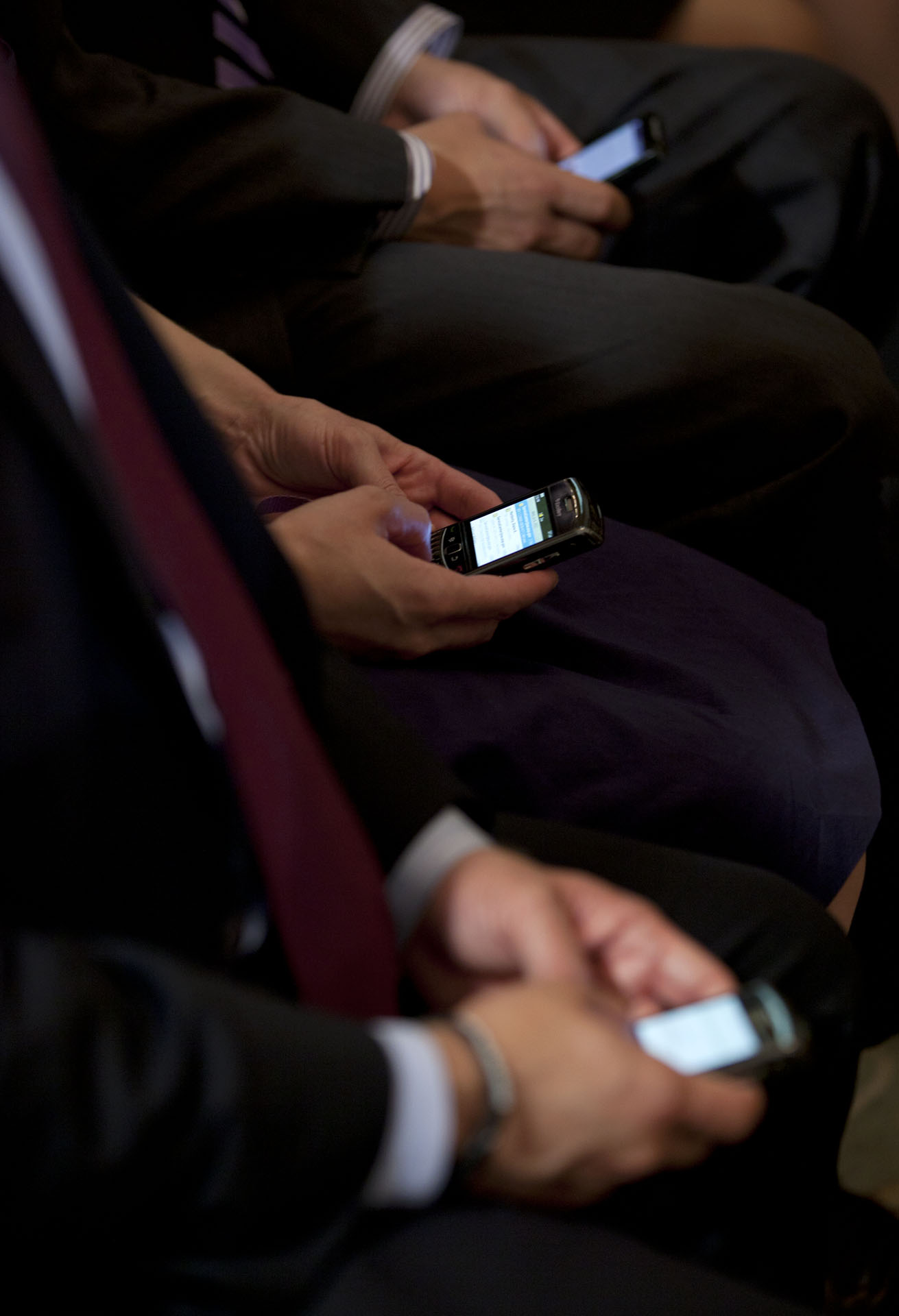 Members of the audience compose Tweets during President Barack Obama's Twitter Town Hall 
