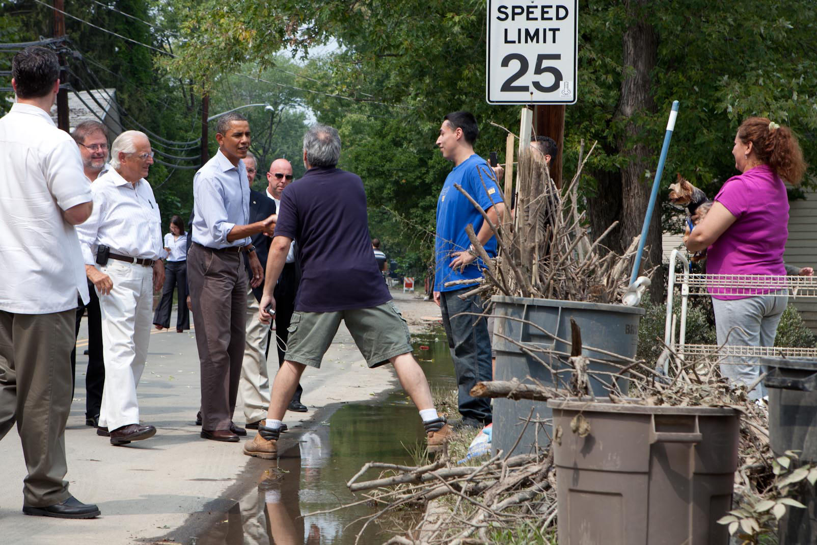 President Barack Obama talks with residents in a neighborhood hit with flooding from Hurricane Irene in Wayne, N.J.