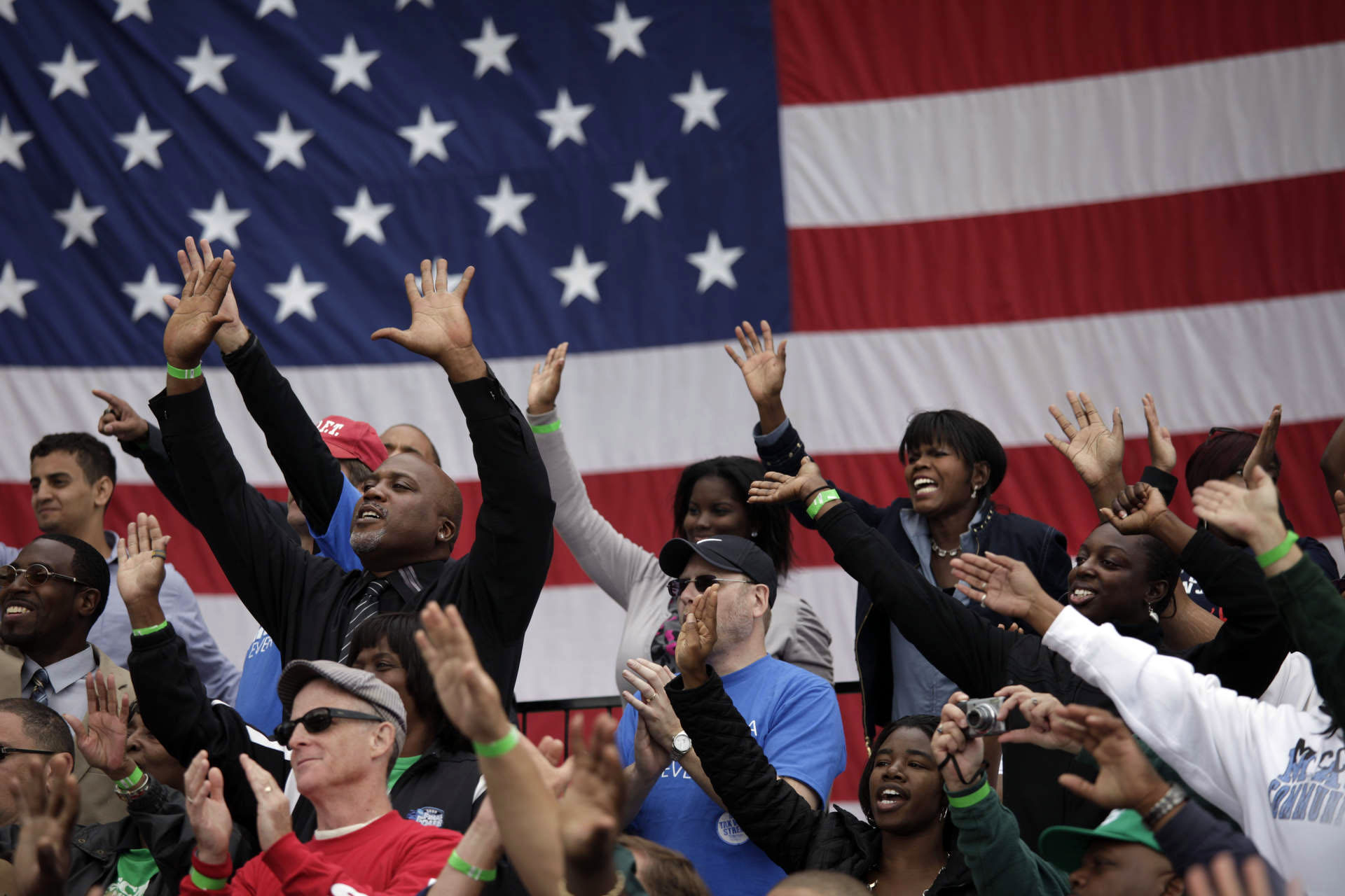 eople wave as President Barack Obama addresses the Labor Day celebration in Detroit, Mich.