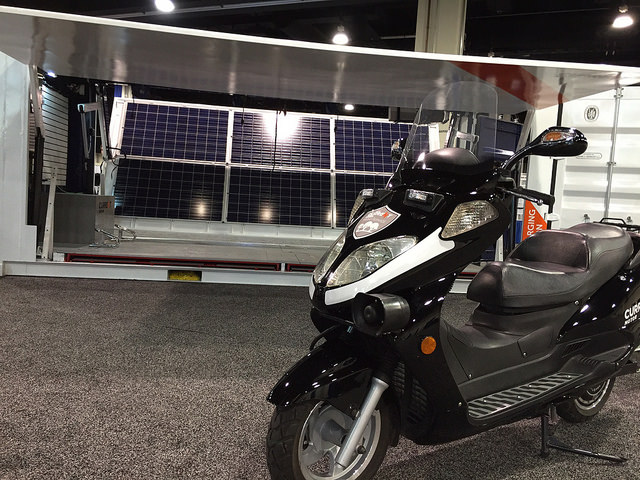 Current Motor’s “Mini-Fleet-in-a-Box” of electric scooters in a shipping container, which doubles as a solar-powered charging station, on display at the ARPA-E Innovation Summit.