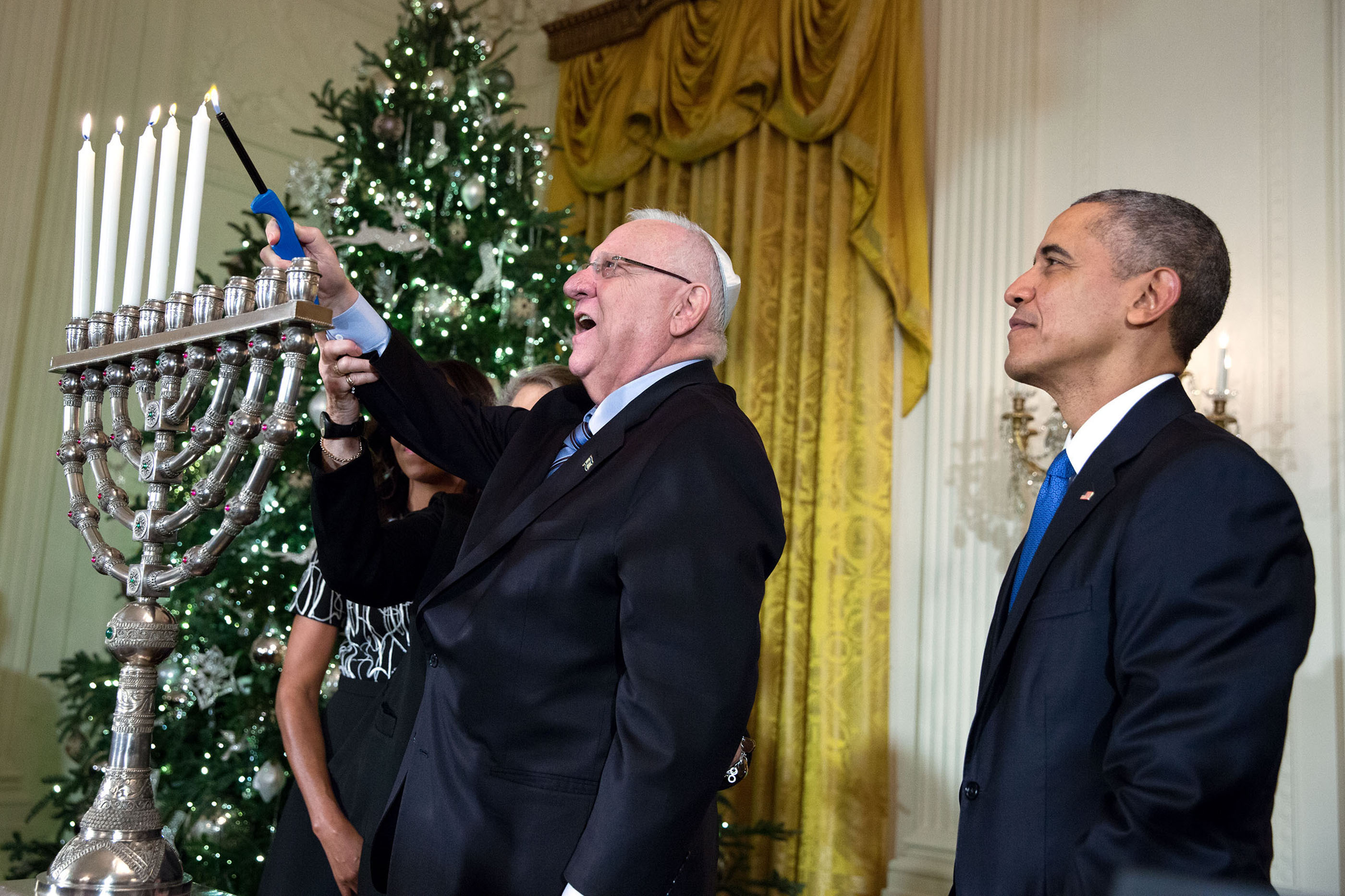 President Barack Obama and First Lady Michelle Obama watch as President Reuven Rivlin of Israel and Mrs. Nechama Rivlin light the menorah during Hanukkah reception #1 in the East Room of the White House, Dec. 9, 2015. (Official White House Photo by Amanda Lucidon)