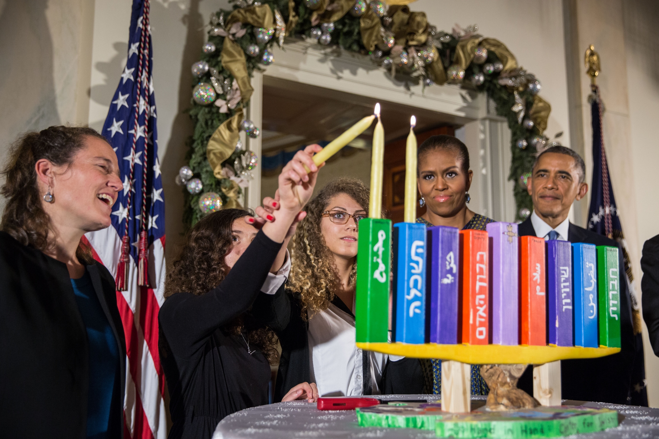 President Barack Obama, First Lady Michelle Obama, Rabbi Bradley Artson, and students from Hand in Hand participate in the Menorah lighting during the afternoon Hanukkah reception in the Grand Foyer of the White House, Dec. 17, 2014. (Official White House Photo by Pete Souza)