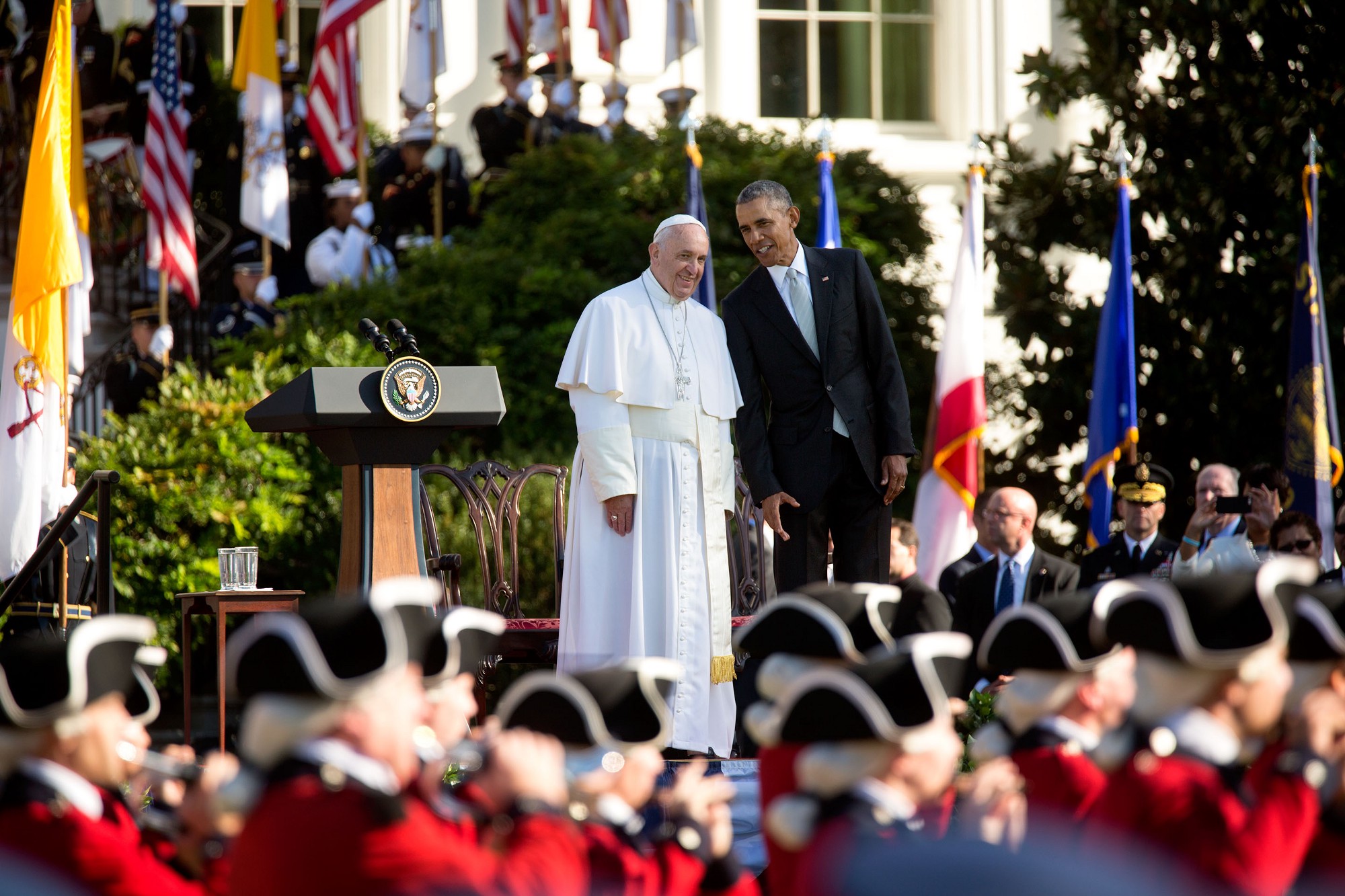 President Obama talks to Pope Francis as the Army Fife and Drum Corps march. (Official White House Photo by Lawrence Jackson)