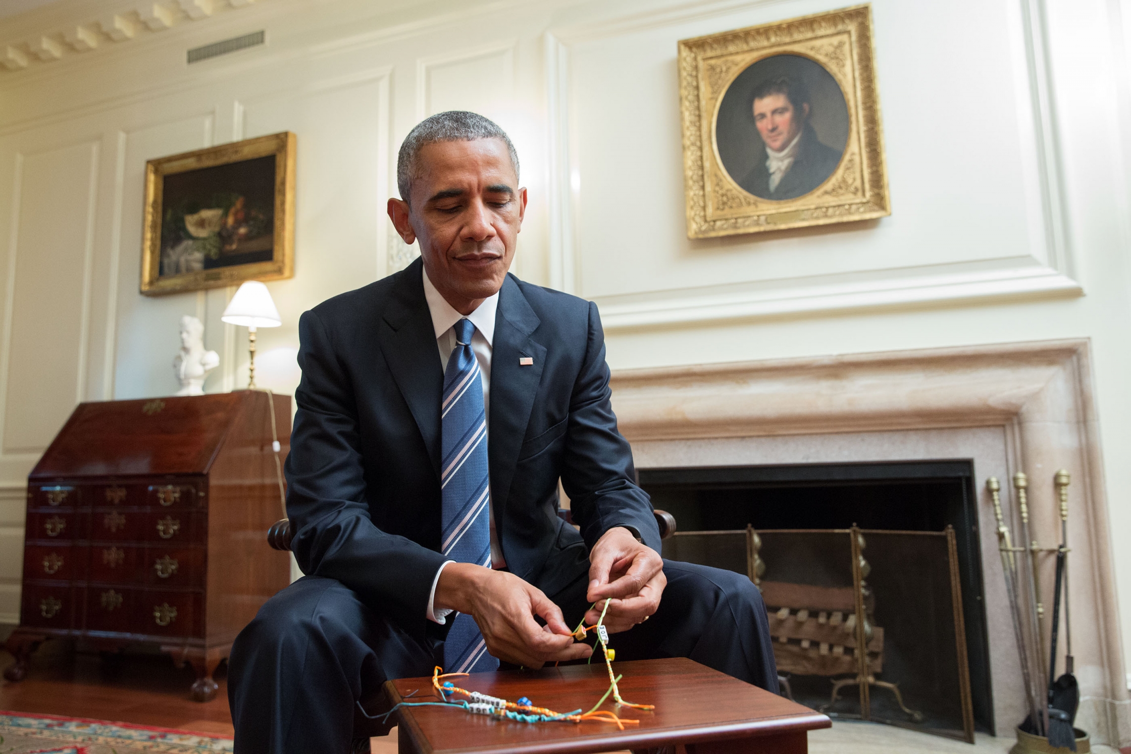 President Barack Obama makes a friendship bracelet while taping a video for Buzzfeed’s TurnUptoVote Week, in the Map Room of the White House, June 23, 2016. (Official White House Photo by Amanda Lucidon)