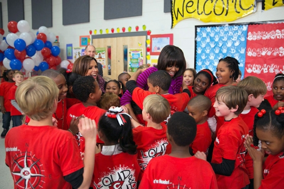 First Lady Michelle Obama and Rachael Ray hug students on the Let's Move 3rd Anniversary Tour