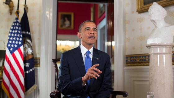 President Barack Obama tapes the Weekly Address and videos in the Blue Room of the White House