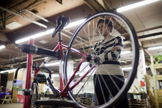 First Lady Michelle Obama with bike at Iron Street Farm