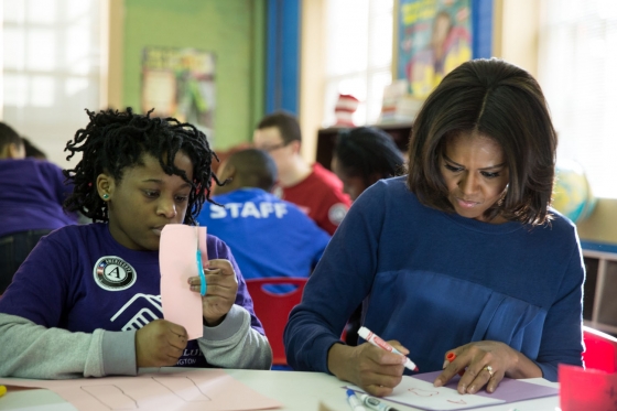 First Lady Michelle Obama works with a young girl during a community service project at the Boys & Girls Club of Greater Washington