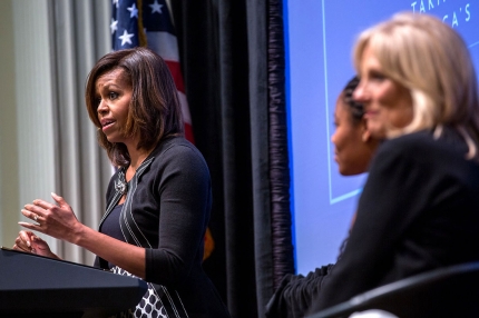 First Lady Michelle Obama, with Dr. Jill Biden and introducer Chrissandra Jackson, delivers remarks during a Joining Forces event at the American Red Cross in Washington, D.C., April 30, 2014.