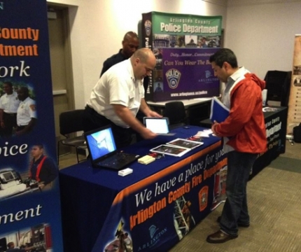 Veterans and military families meet with recruiters at a Veterans Career Fair in Arlington, VA on May 15, 2014.