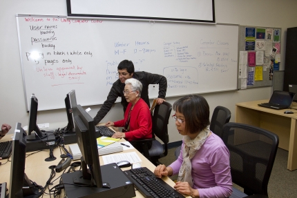 Luis Rios helps Gui Ying Lee and Shuo Chau Yang enroll in the Health Insurance Marketplace