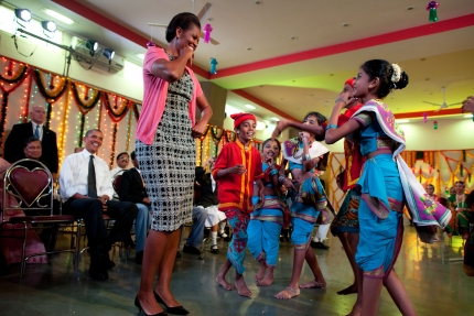 First Lady Michelle Obama dances with students during Diwali 