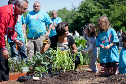 First Lady Plants Garden with Native American Children