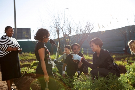 First Lady Michelle Obama works on a service project in Soweto