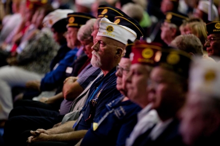 Veterans listen as President Barack Obama delivers remarks to the American Legion