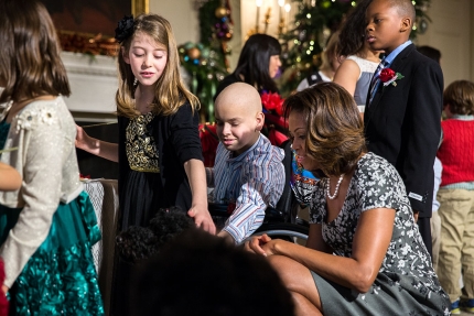 First Lady Michelle Obama and children of military families greet Obama family pet Sunny in the State Dining Room during the White House holiday press preview, Dec. 4, 2013.  (Official White House Photo by Amanda Lucidon)