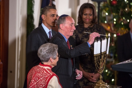 Holocaust survivors Margit Meissner and Martin Weiss participate in the Menorah lighting with President Barack Obama and First Lady Michelle Obama
