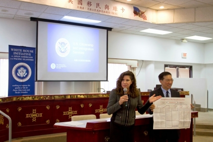 Susan M Curda (left) gives opening remarks and introduces the USCIS staff