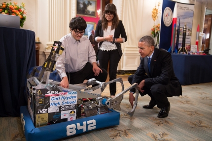 President Obama looks at two Arizona students' robot at the fifth annual White House Science Fair 
