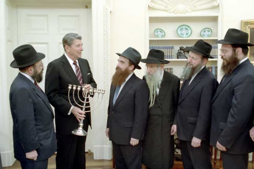 Ronald Reagan receives a Menorah from the Friends of Lubavitch in the Oval Office on December 17, 1979.