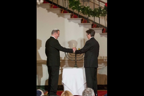 Yariv Ben-Eliezer, grandson of David Ben-Gurion, and Clifton Truman Daniel, grandson of Harry S. Truman, light the menorah for the annual White House Hanukkah Reception, December 15, 2008.