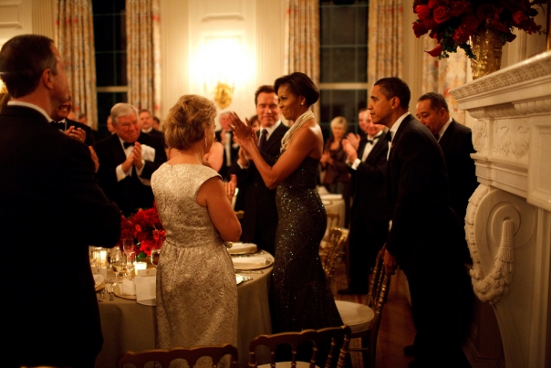 President Barack Obama pulls out the chair for First Lady Michelle Obama at the Governors Ball 