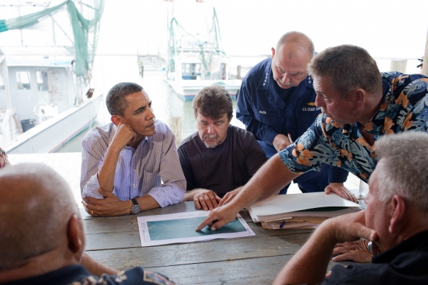 President Barack Obama looks at maps of local estuaries with Mayor David Camardelle