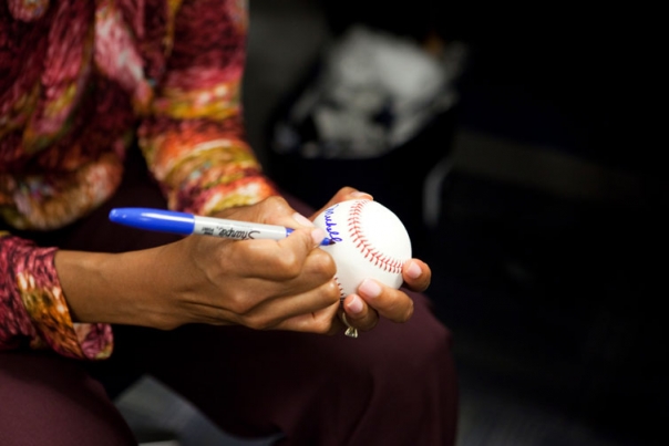 First Lady Michelle Obama Signs a Baseball at Yankee Stadium 