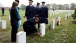 President Barack Obama leaves a presidential coin at the gravesite of 19-year-old Medal of Honor recipient