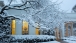 Oval Office lights are seen from the snow covered South Grounds