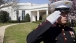 A Marine Salutes as President Obama Returns to the Oval Office