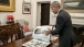 President Obama looks at photos of Muhammad Ali