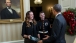 President Barack Obama receives a framed copy of the Marine Helicopter Squadron One (HMX-1) Christmas holiday greeting card