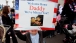 A Young Boy Holds a "Welcome Home" Sign at  Homecoming Ceremony for the USS Gettysburg