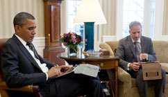 President Obama looking at his IPad.