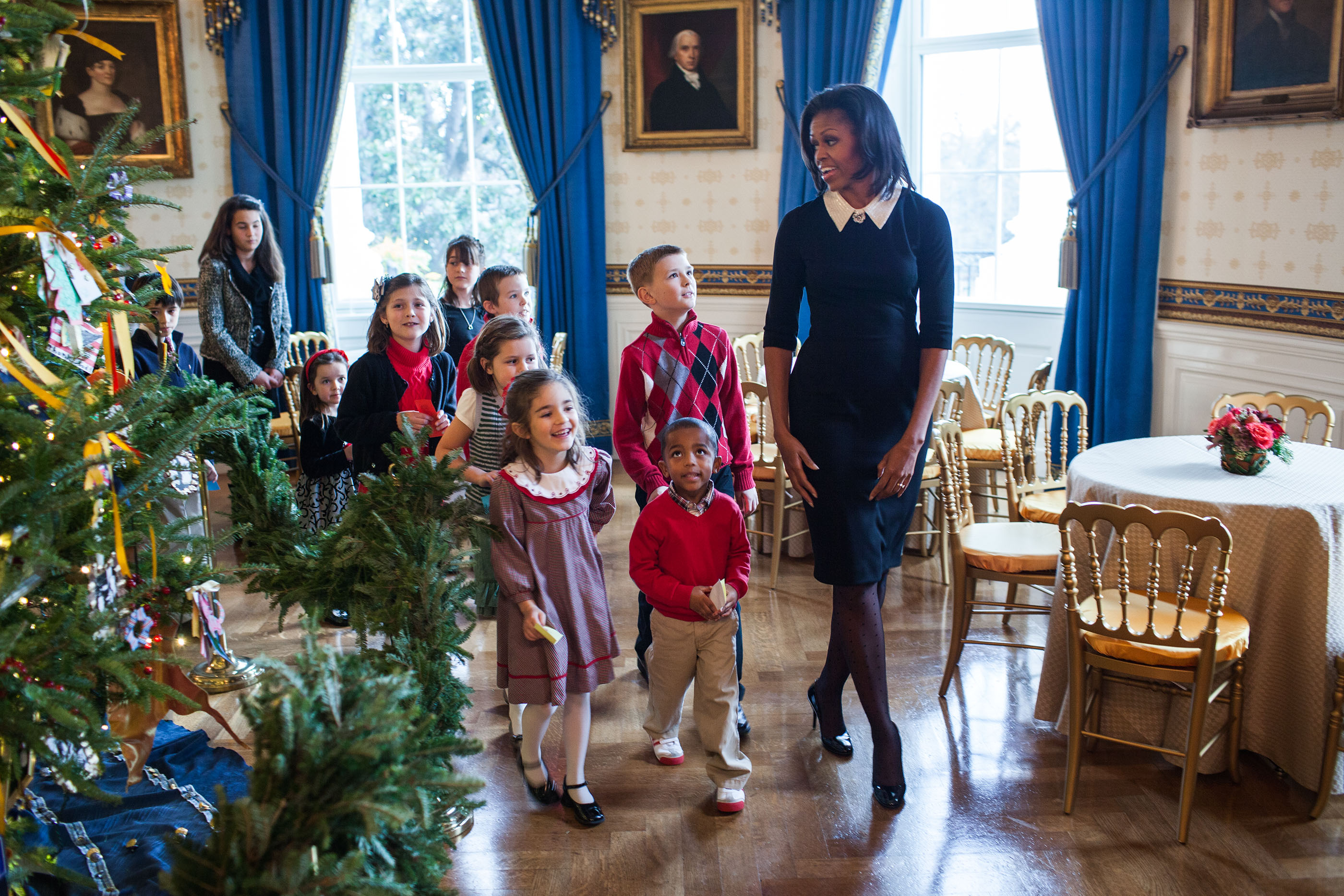 The First Lady walks with children past the official White House Christmas Tree in the White House, Nov. 30, 2011. (Official White House Photo by Lawrence Jackson)