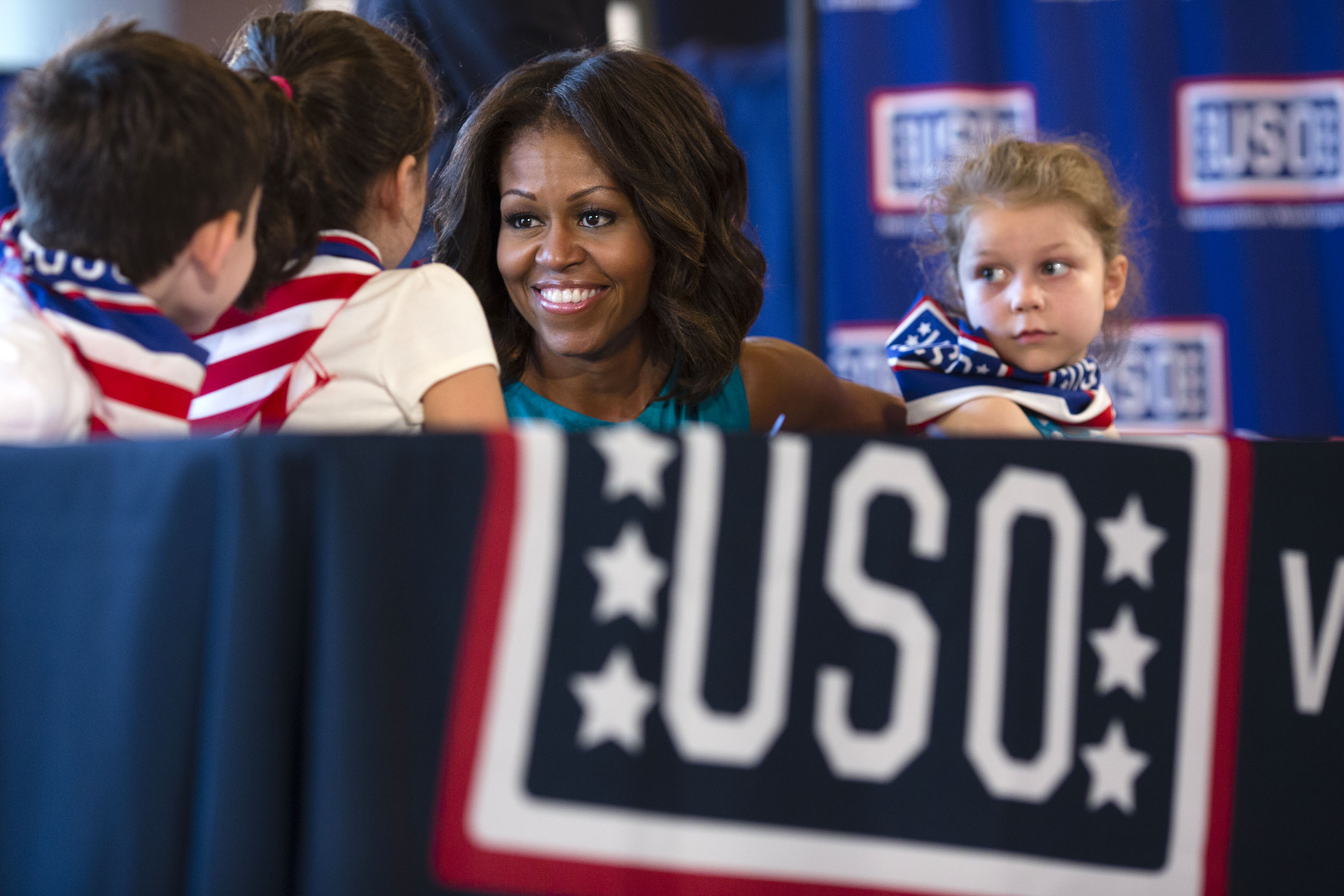 The First Lady joins children in an American flag art project at the USO Warrior and Family Center in Ft. Belvoir, Va. Sept. 11, 2013. (Official White House Photo by Lawrence Jackson)