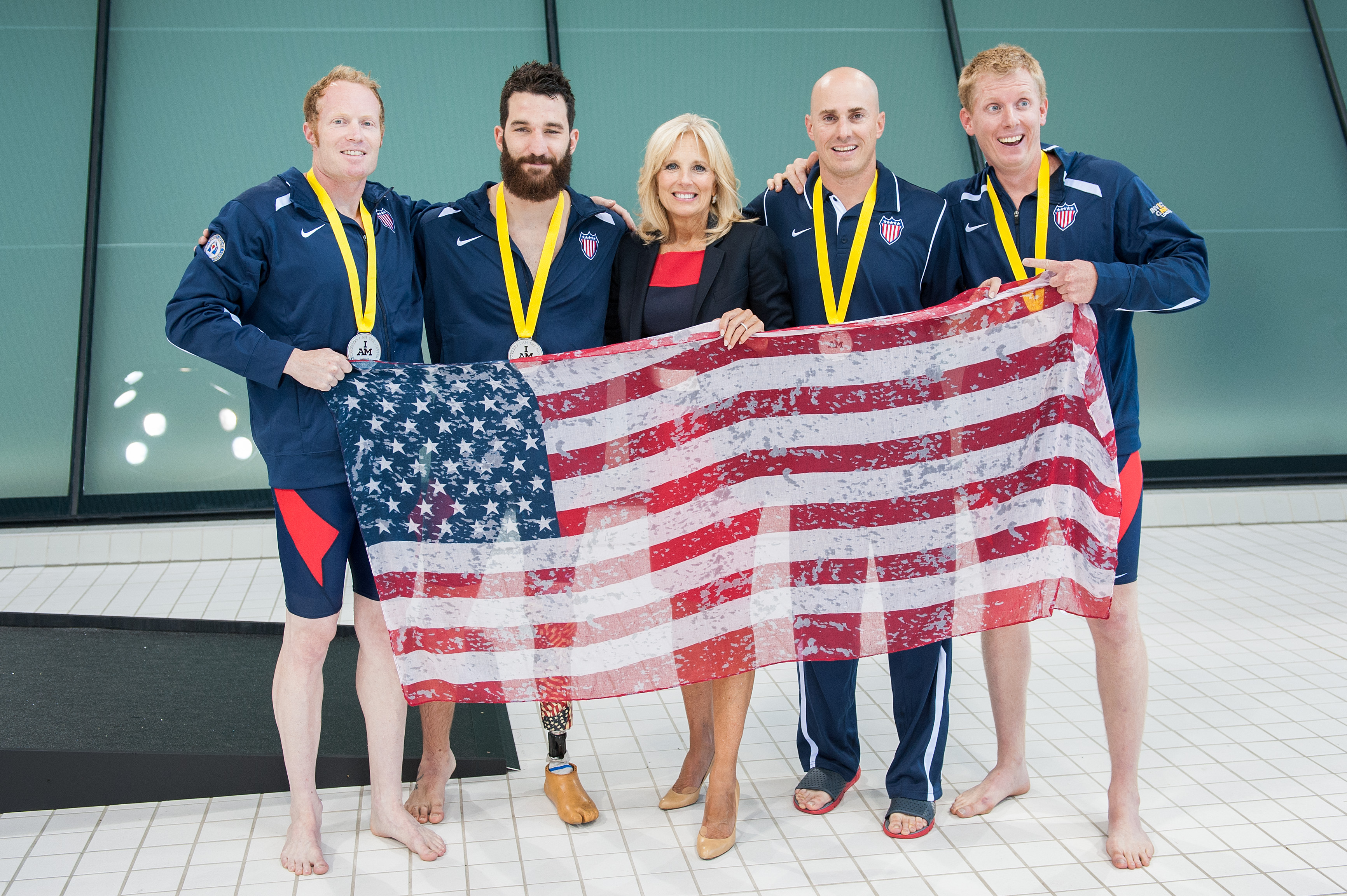 Dr. Jill Biden awards medals to US Team swimmers after winning the silver at the Invictus Games in London, UK, September 14, 2014. (Photo by James Pan, State Department)