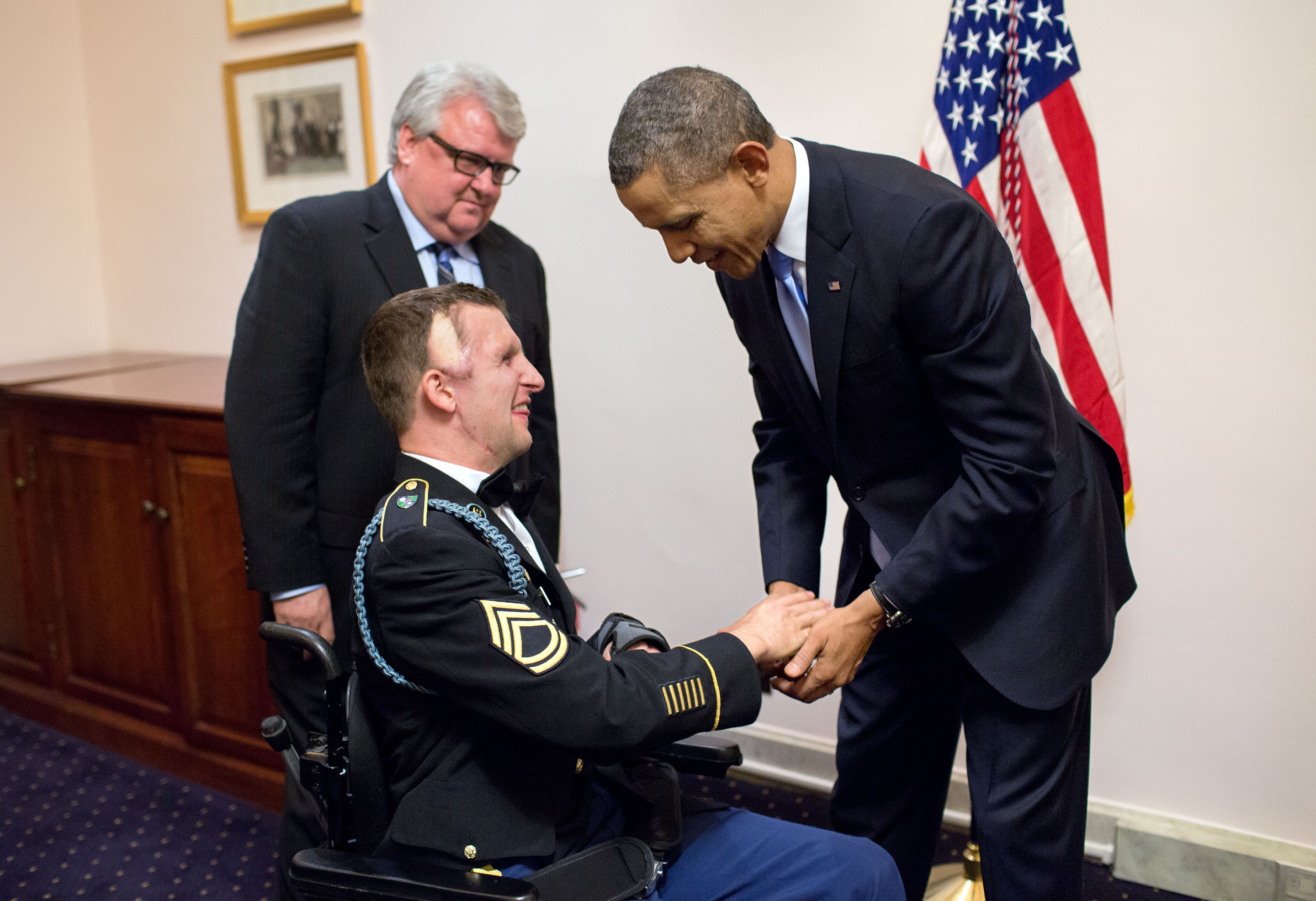 Jan. 28, 2014: Cory, with his father Craig, gives a Ranger Challenge Coin to the President following his State of the Union address. (Official White House Photo by Pete Souza)