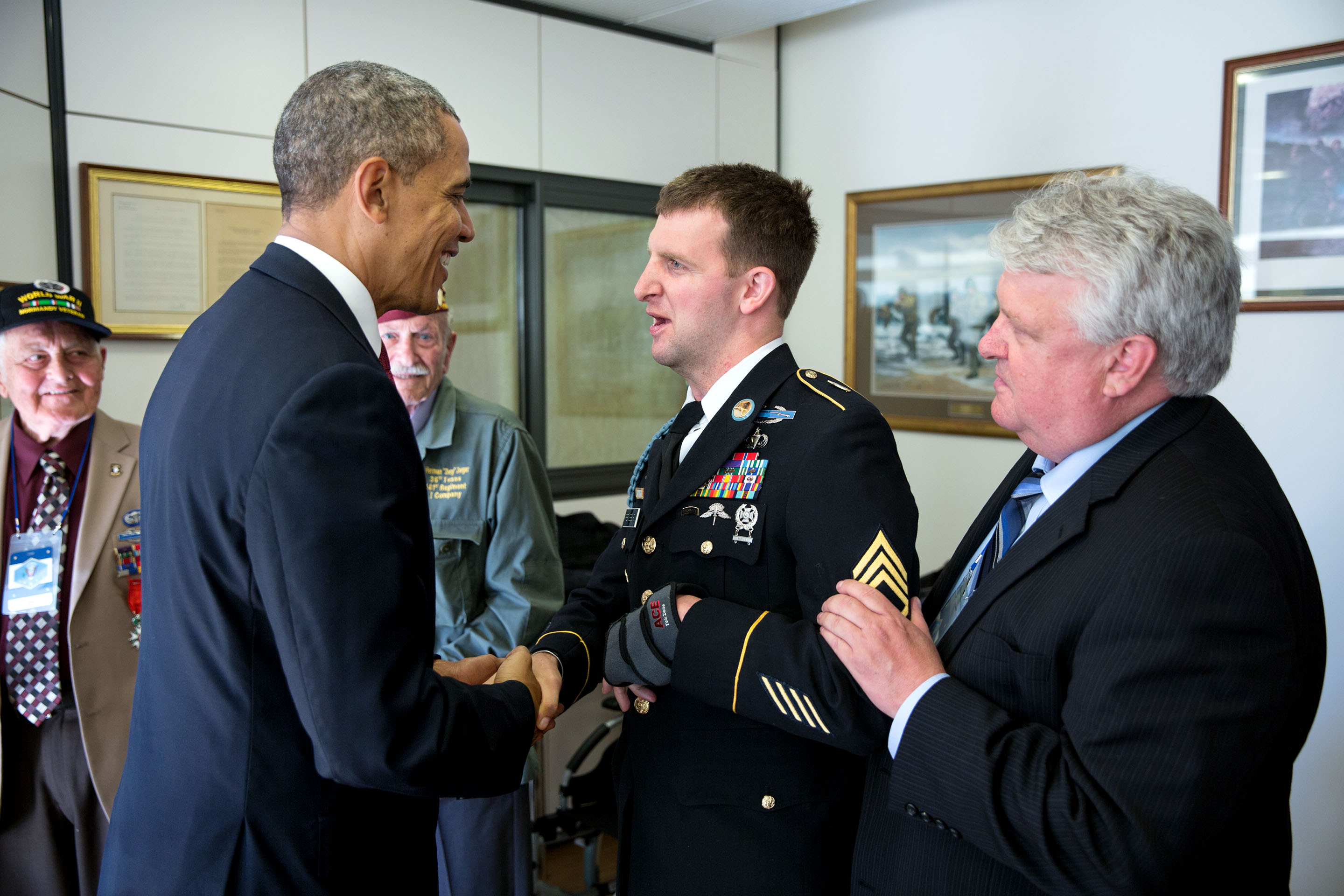 June 6, 2014: The President greets Cory and his father Craig and U.S. WWII veterans prior to the 70th anniversary of D-Day in Normandy. (Official White House Photo by Pete Souza)