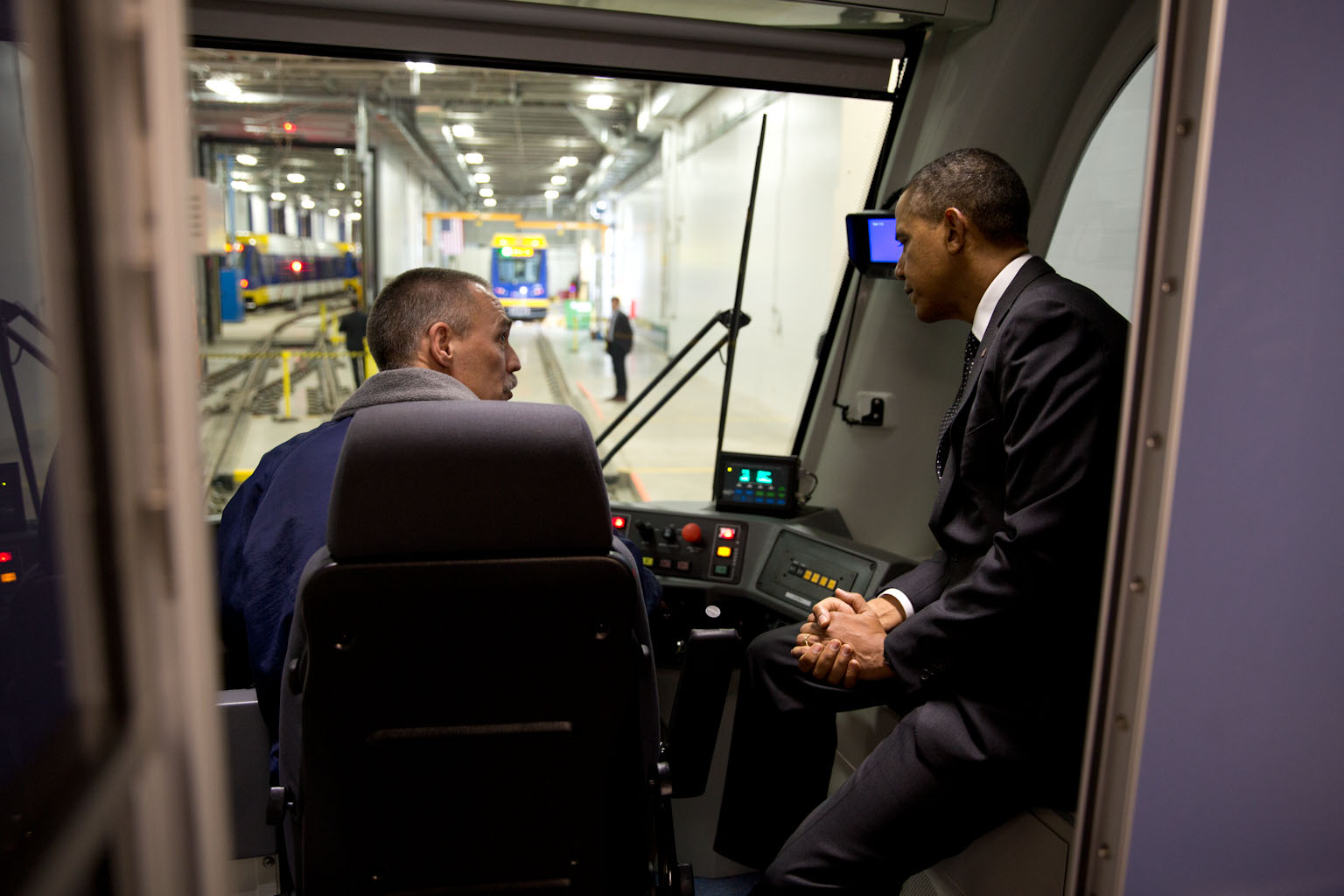 President Barack Obama sits in the cab and talks with a worker during a tour of the Light Rail Maintenance Building in St. Paul, Minn., Feb. 26, 2014.