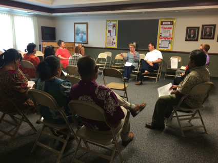 Community members participate in a community roundtable in Springdale, AK