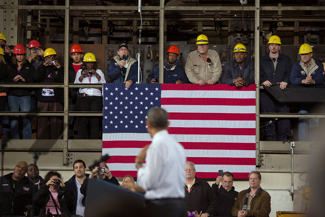 Workers listen as President Barack Obama delivers remarks at the ArcelorMittal Steel factory in Cleveland, Ohio