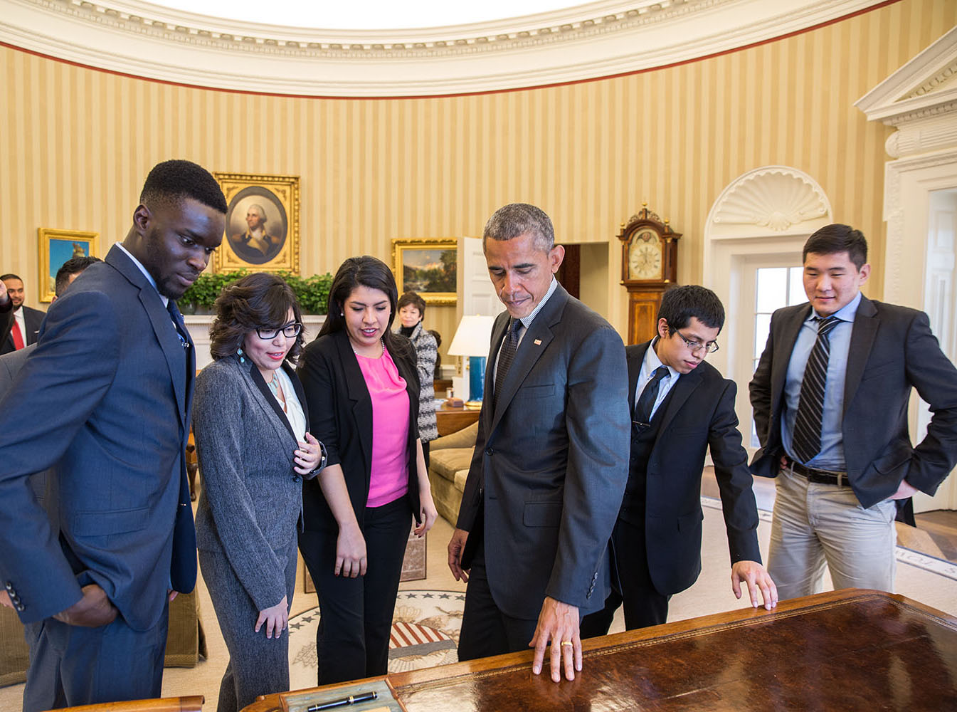 President Barack Obama shows the Resolute Desk to a group of DREAMers, following their Oval Office meeting in which they talked about how they have benefited from the Deferred Action for Childhood Arrivals (DACA) program, Feb. 4, 2015.